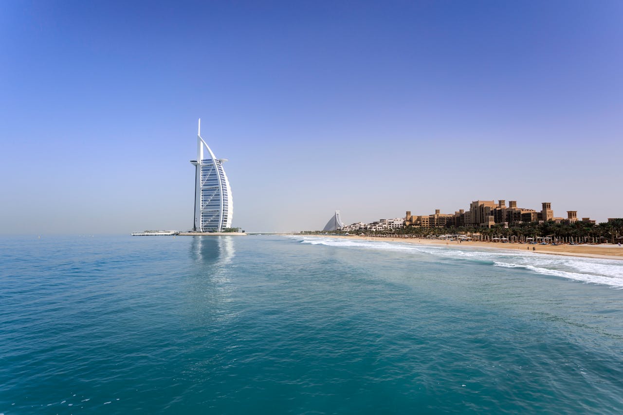 Home Iconic Burj Al Arab overlooking the pristine Dubai beach, perfect for travel and leisure.