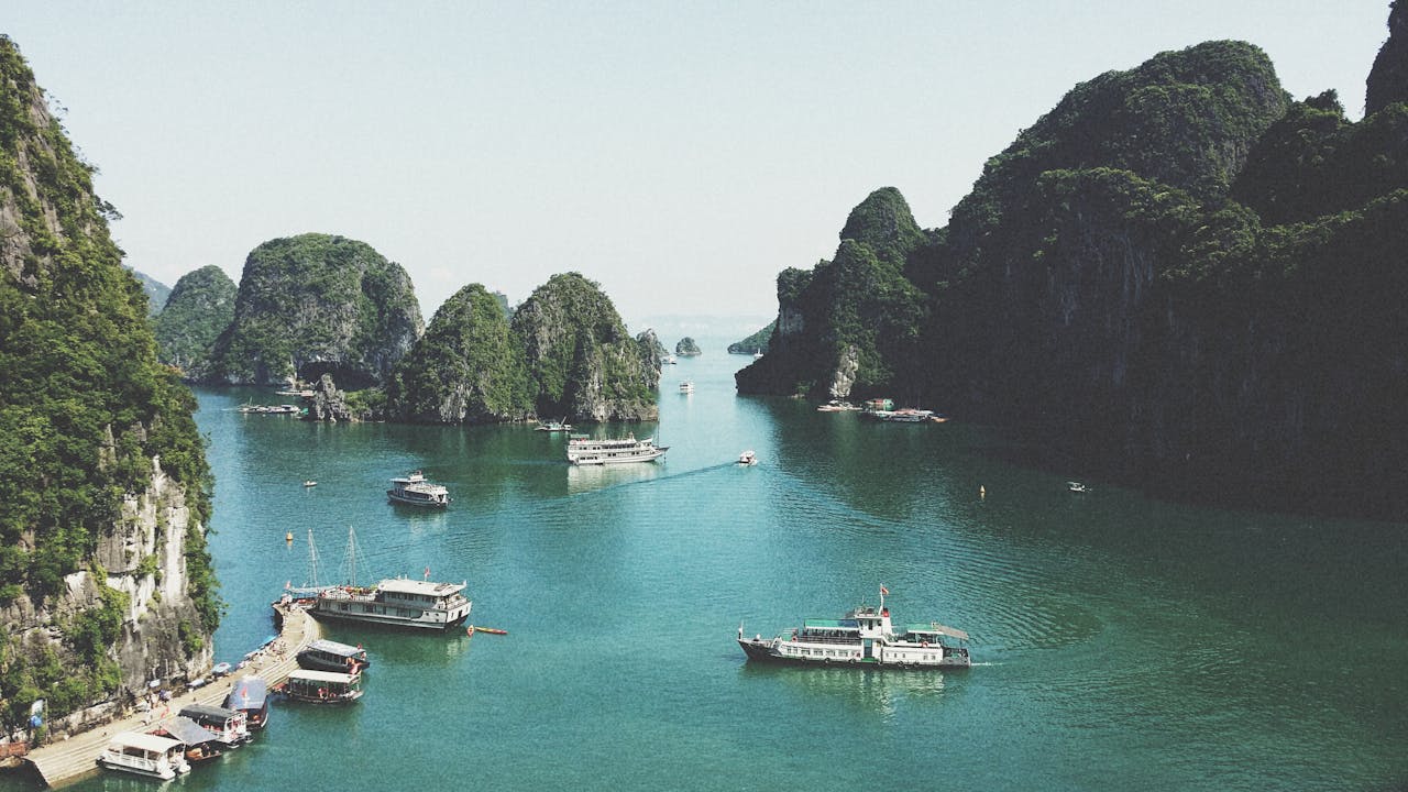The Art of Drawing Readers In: Your attractive post title goes here A breathtaking view of Halong Bay with boats navigating through limestone islands.